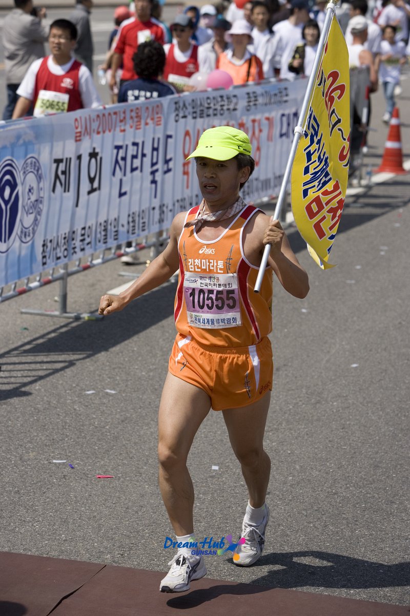 깃발을 들고 달리는 마라톤 대회 참가자