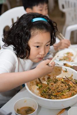 보리비빔밥을 먹는 어린이의 모습