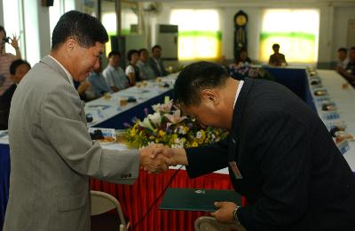 중미동 석성면 자매결연 체결문을 교환하고 악수하시는 석성면장님과 중미동장님