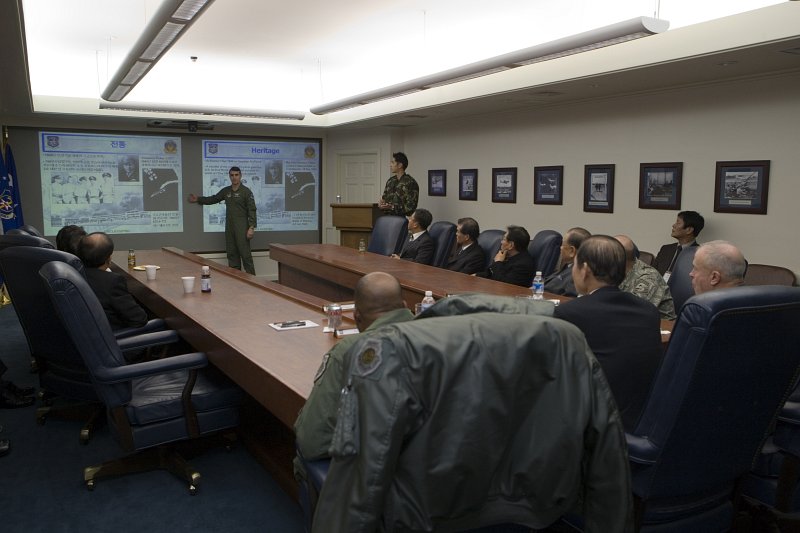 한국어와 영어로 나누어 자료를 준비해 발표하고 있는 미군과 듣고 있는 시장님과 임원들과 미군대표들1