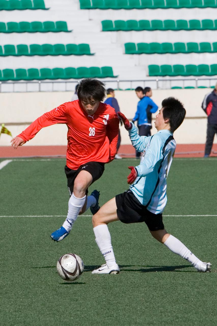 축구공을 향해 달려드는 두 선수