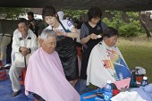 결연 어르신 큰잔치에서 어르신들의 머리를 자르고 있는 봉사자들사진(00001)