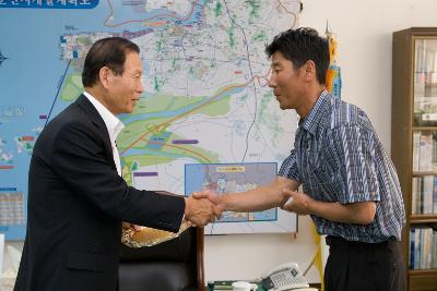 어청도주민대표께 감사패를 수여받으며 악수를 나누고 있는 시장님