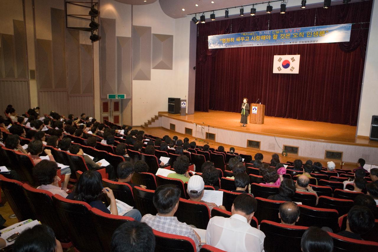 무대 위로 올라와 강연을 하고 있는 신달자 강사와 객석에 앉아 강연을 듣고 있는 사람들2