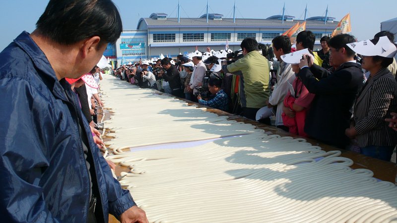 길게 이어져 있는 가래떡을 쳐다보고 있는 사람들3