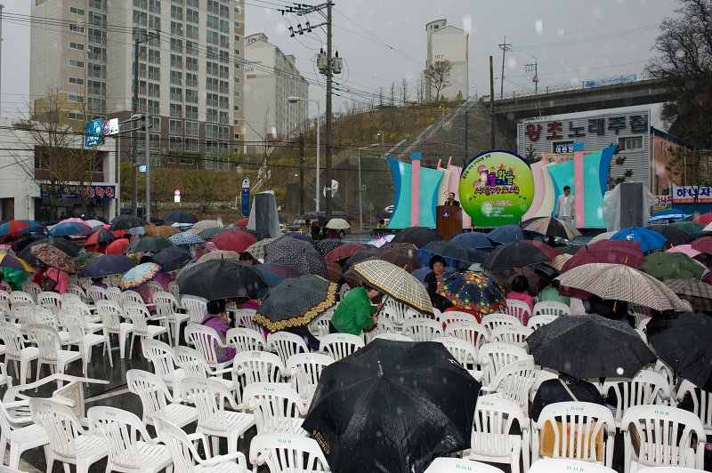 연설 중이신 시장님.비가와도 우산을 쓰며 모여있는 관객들1